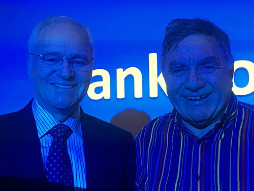 ANZSREI President Prof Michael Chapman with Dr David Adamson in front of the conference screen